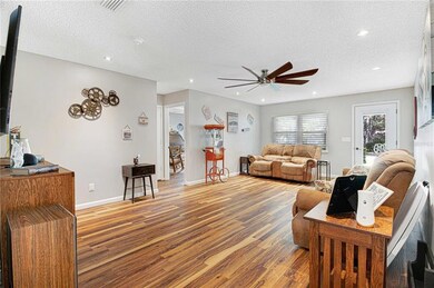Living room with recessed lighting, new ceiling fan and luxury vinyl plank flooring