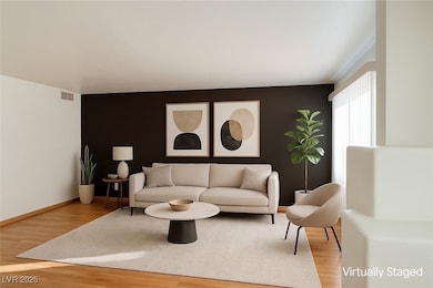 Living room featuring wood finished floors and bas