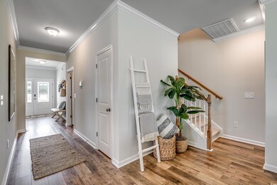 Hall with crown molding and hardwood / wood-style 