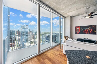Living area featuring a city view, a ceiling fan,