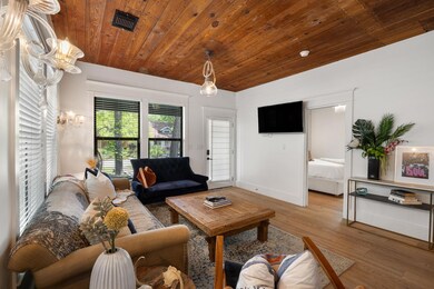 Living room with wood finished floors, wooden cei