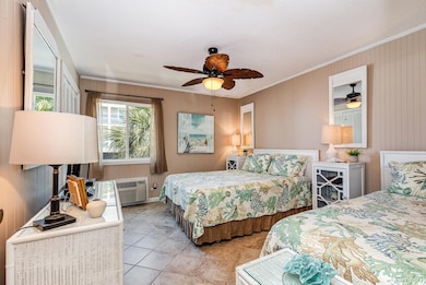 Bedroom with light tile patterned floors, an AC wall unit, ornamental molding, and a ceiling fan