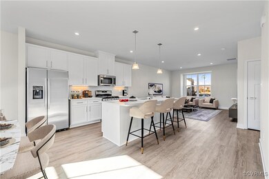Kitchen featuring light wood-type flooring, a cent