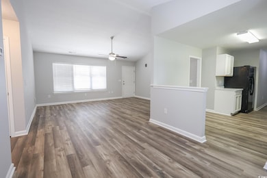 Unfurnished living room with ceiling fan, a textur