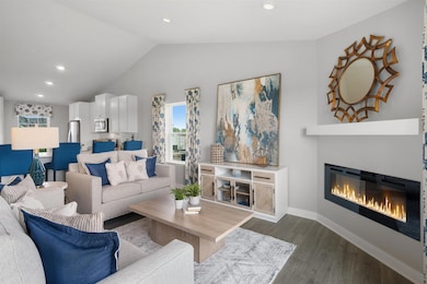 Open concept living with a modern electric fireplace. Our smart home package is included in every home.