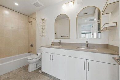 Full bath boasting double vanity and ample storage