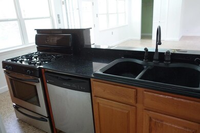 Full kitchen with all appliances including fridge.
