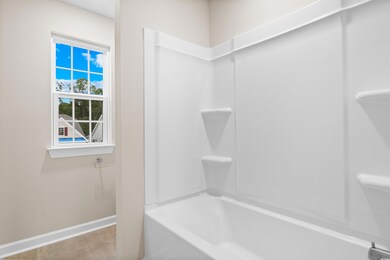 Bathroom with tile patterned flooring and bathtub 