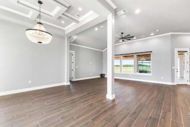 Unfurnished living room featuring ornamental mold