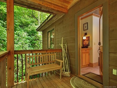 THE SPACIOUS COVERED PORCH INVITES YOU TO REST OR 