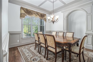 Dining room featuring a chandelier, dark wood-type