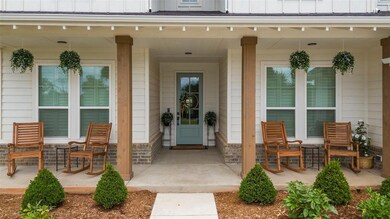 Doorway to property featuring board and batten siding and a porch