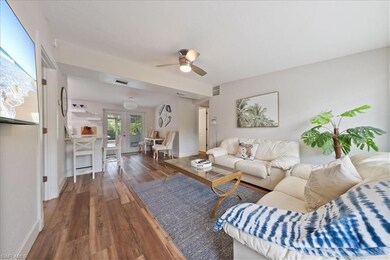 Living room with ceiling fan, wood finished floors