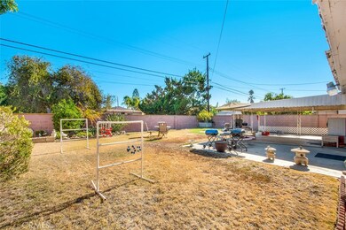 BACKYARD FULLY ENCLOSED WITH CINDER BLOCK WALLS IN GREAT CONDITION AND LARGE CONCRETE PATIO WITH COVER