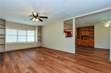 Unfurnished living room with dark wood-type floori