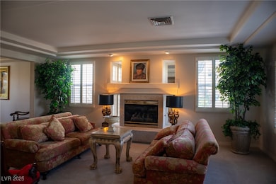 Carpeted living area with a high end fireplace, pl