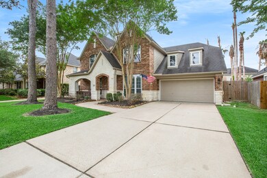 Great curb appeal with brick and stone, large trees and a 2-car garage with a double-wide driveway.