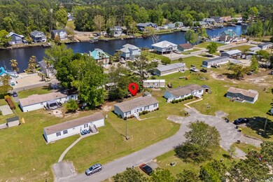 Birds eye view of property featuring a water view, a forest view, and a residential view