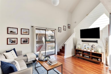 Living area featuring wood finished floors, stair