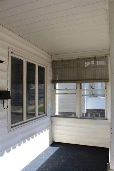 Front porch has windows to enjoy in all weather an