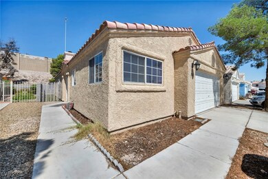 View of property exterior with stucco siding, a ga