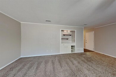Carpeted spare room featuring ornamental molding