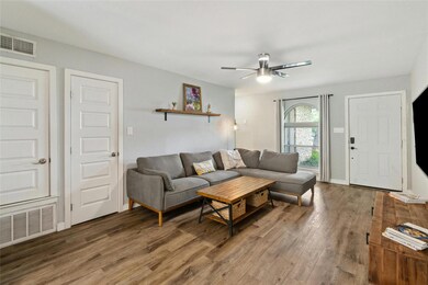 Living room featuring ceiling fan and wood finish