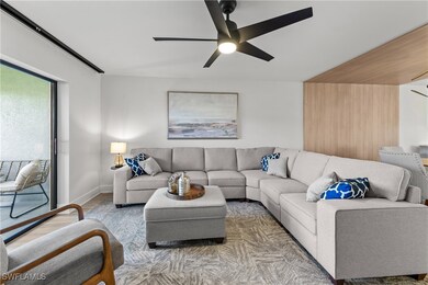 Living room with ceiling fan and wood-type floorin