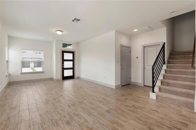 Entryway with light wood-style floors, stairway, 