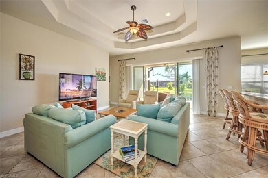 Tiled living room with a tray ceiling and ceiling 