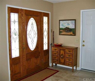 Elegant entryway opens to entertainment room.