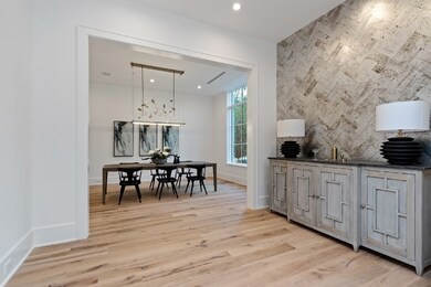 The formal powder room and elevator face the opposite side of the tile wall