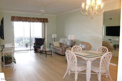 Dining area with ceiling fan with notable chandeli