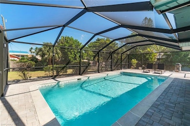 Swimming pool featuring glass enclosure, a sunroom, and a patio
