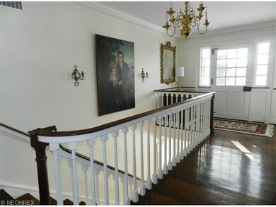 The upper foyer shows the wide plank flooring and 