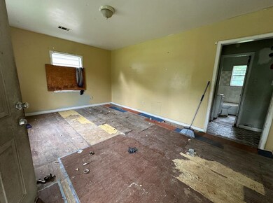 Spare room featuring baseboards