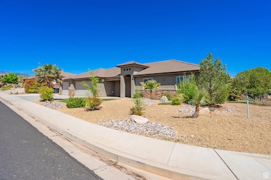 View of front facade with a tiled roof, stucco siding, an attached garage, driveway, and stone siding