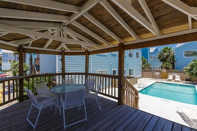Wooden terrace with fence, a community pool, a pa