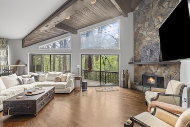Living room with vaulted wood ceiling.