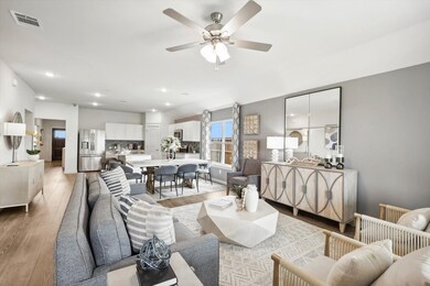 Living room with light wood-type flooring, a ceiling fan, and recessed lighting