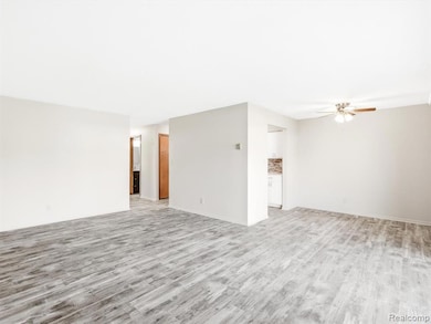 Spare room with wood finished floors and ceiling fan