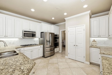 Kitchen featuring backsplash, ornamental molding,