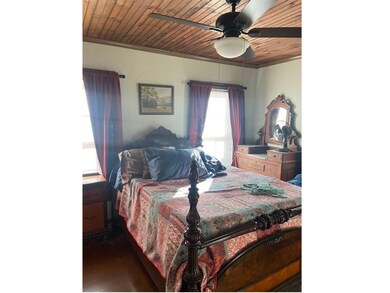 Bedroom with wood ceiling, ceiling fan, ornamental