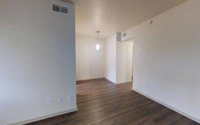 Empty room featuring dark hardwood / wood-style fl