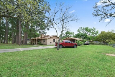 Side view of home with large trees, nice sized sid