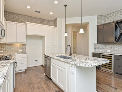 Kitchen with a sink, visible vents, stainless ste