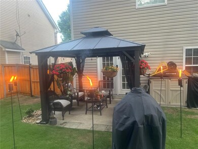 View of patio with a gazebo and grilling area