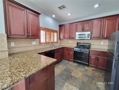 Kitchen featuring black appliances, dark brown cab