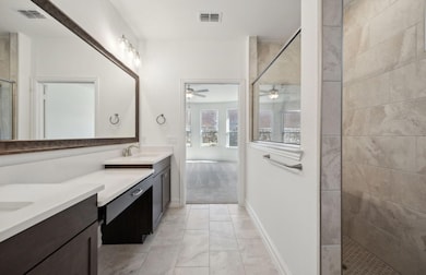 Elegant owner's bathroom with dual vanity and over