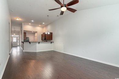 Unfurnished living room featuring dark wood-type f